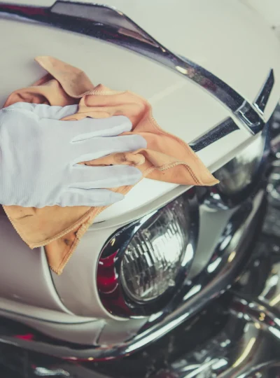 Taking Care of Classic Car. Passionate Vintage Cars Collector Cleaning One of His Vehicle. Closeup Photo.